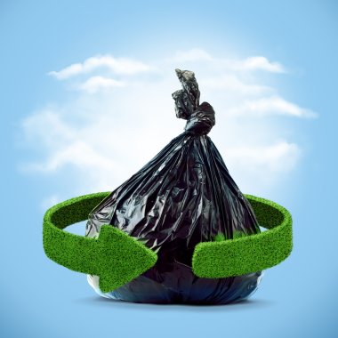 Garbage bag and green arrows from grass. Recycling concept clipart