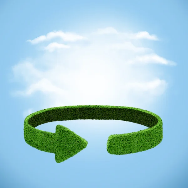 Green arrows  from the grass on sky background. Recycling concept — Stok fotoğraf