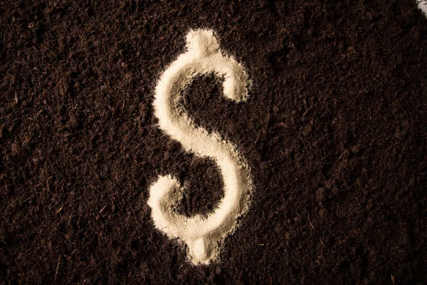 Dollar symbol written on brown ground — Stock Photo, Image