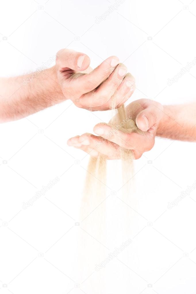 A sand in the hands. Isolated on a white background