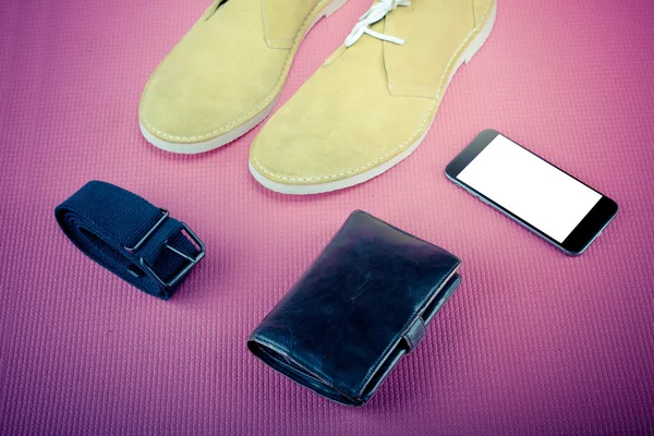 Green male shoes with laptop and mobile phone on pink background — Stock Photo, Image
