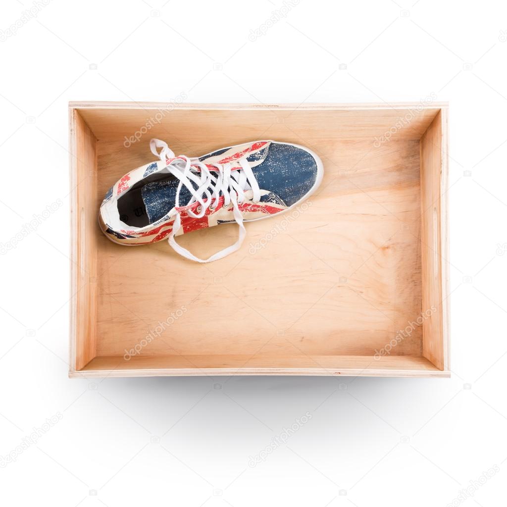Top view of  wooden box with shoes inside