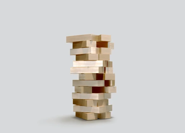 Bloquea jenga juego de madera sobre fondo gris . — Foto de Stock