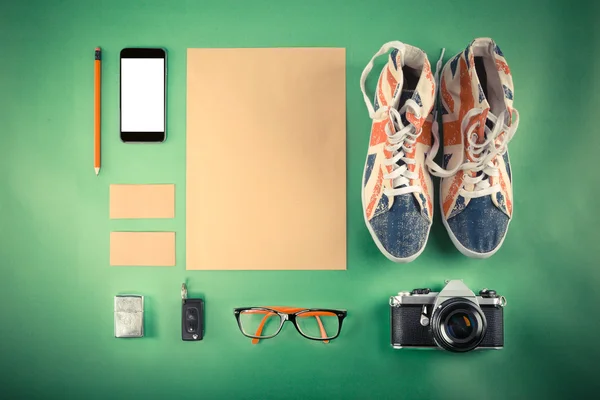 Set of Retro hipster mock up. Laptop, old camera, tablet and smoke pipe on green background. Filtered image