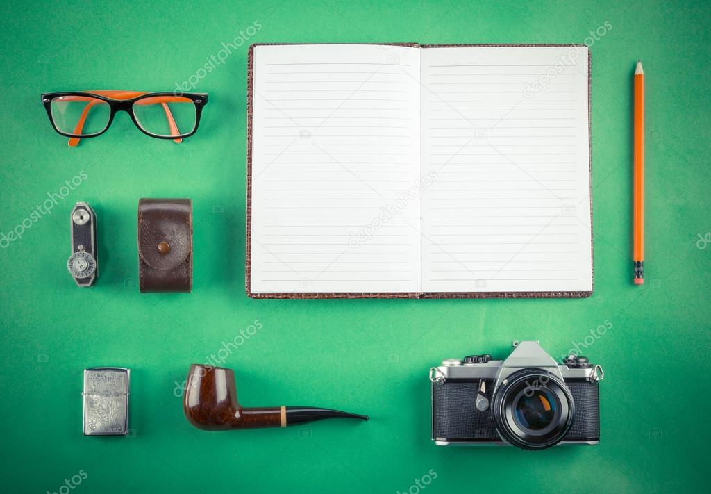 Set of Retro hipster mock up. Laptop, old camera, tablet and smoke pipe on green background. Filtered image