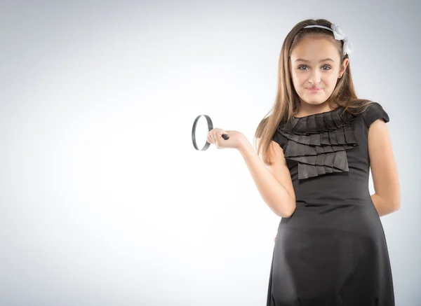 Cute  little girl with magnifying glass in hands. Educational concept — Stock Photo, Image