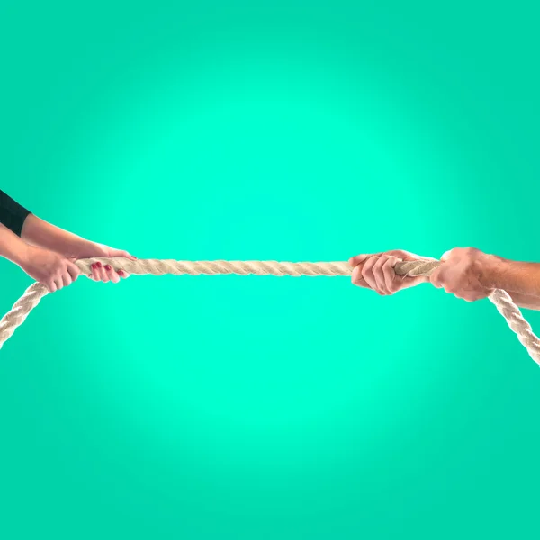 Hands of people pulling the rope on a green background.  Competition concept — Stock Photo, Image