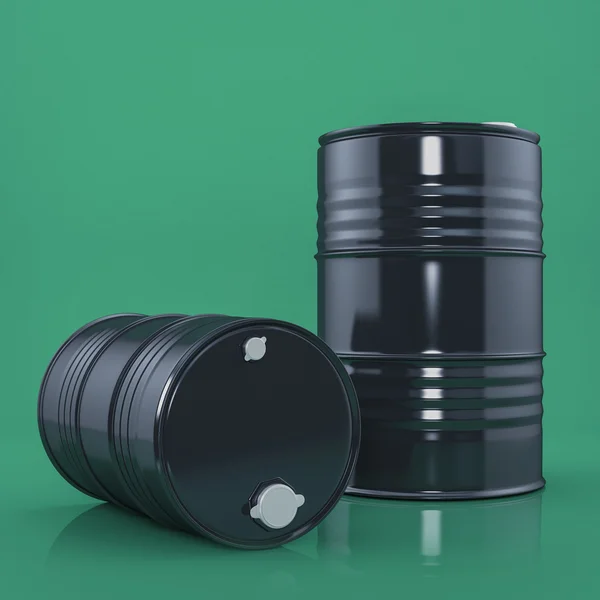 Two black metal barrels on green color background. Front view — Stock Photo, Image