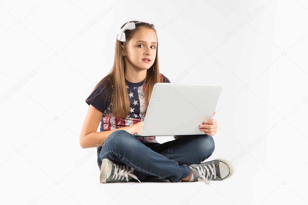 Little pretty girl studying with computer. isolated on white background
