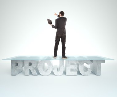 Confident business man standing on the PROJECT table design. Bussines concept