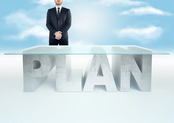 Confident business man standing near a PLAN table on sky backrgound. Bussines concept — Stockfoto