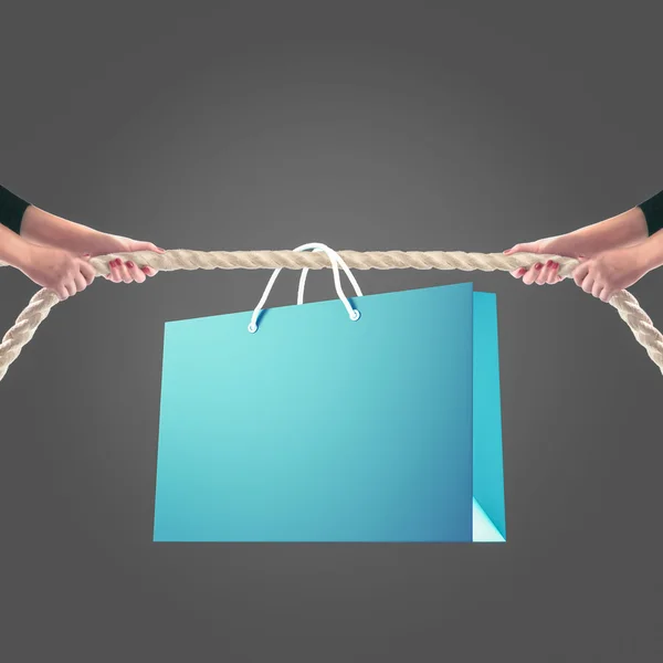 Hands of people pulling the rope on white background. Shopping concept — Stockfoto