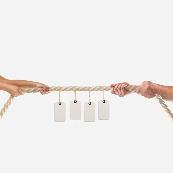 Hands of people pulling the rope on white background. Shopping concept — Stock Fotó