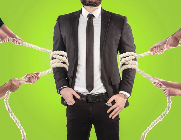 Hands of people pulling the rope on color background. Search employee concept — 图库照片