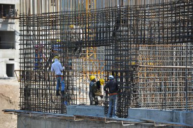 Almaty / Kazakistan - 07.02.2012: Evin şantiyesindeki işçiler beton bloklar için kaynak demiri ve tamiri ile meşgul
