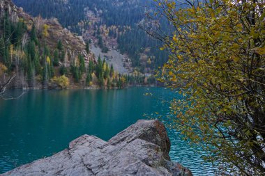 Lake Issyk in the rays of the setting sun. National Nature Park. Mountainous area with different vegetation.
