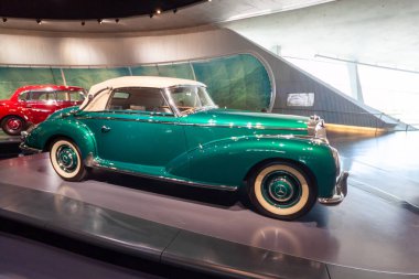 STUTTGART, GERMANY - OCTOBER 18, 2025: Side view of a luxury green 1950s Mercedes-Benz 300 S Cabriolet A exhibited in the Legend 4 hall at the Mercedes-Benz Museum