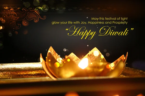 Golden lotus shaped diya on abstract Diwali background — Stock Photo, Image