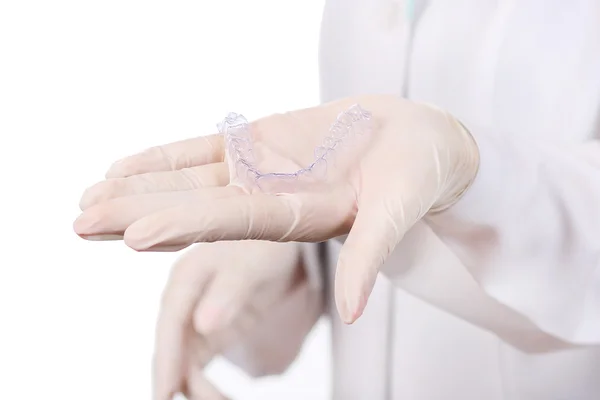 Close-up shot of doctors hands in gloves holding silicone mouth guard. Teeth care — Stock Photo, Image