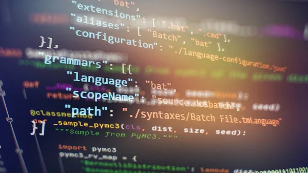 Website development. Developer working on program codes in office. Computer program. Programmer workplace. Programming code. Software source code.