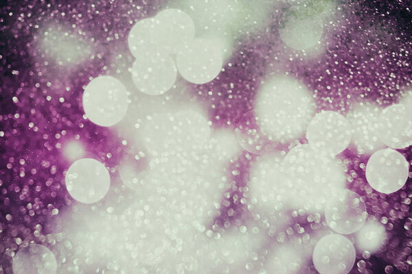 Festive background with natural bokeh and bright purple lights. Vintage Magic background with colorful bokeh. Spring Summer Christmas New Year .