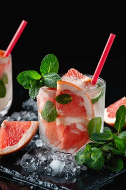 Fresh grapefruit cocktail. Fresh summer cocktail with grapefruit and ice. Glass of grapefruit mojito. Copy space.	