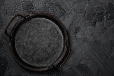 Empty metal tray on a grey background. Space for text.	