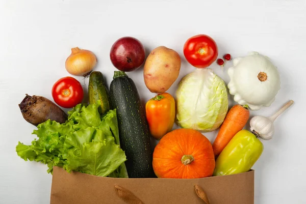 Paper bag with vegetables on white background — Stock Photo, Image