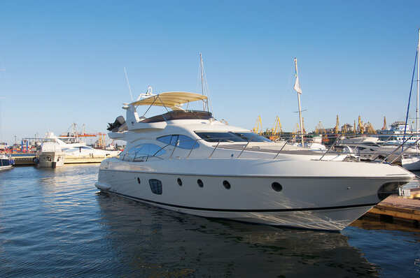 White yacht in the port. On the sea calm.