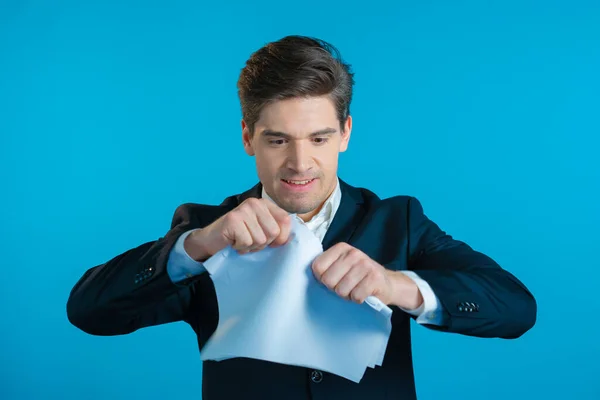 Angry businessman tearing contract in pieces. Furious male office worker throwing crumpled paper, having nervous breakdown at work, screaming in anger, stress management.