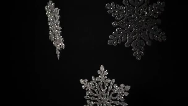 Decorative shining snowflakes rotating black wall — Stock Video