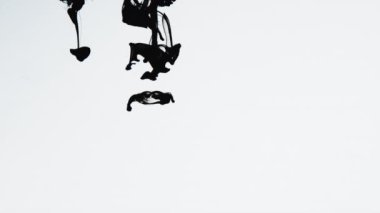 Suda siyah mürekkep. Boya suda reaksiyona girerek beyaz arka planda soyut bulut oluşumları yaratır. Modern sanat projelerine eklenerek geçiş olarak kullanılabilir. Yavaş çekim.