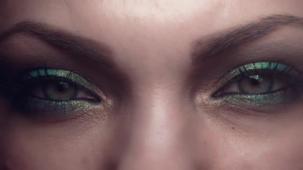 Female eyes only. Woman with beautiful make-up, green glitter shadows. Girl blinking, contracting. Beauty, cosmetics, art, feminine concept. — Stock Video