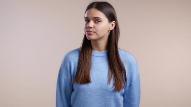 Serious woman disapproving with no head sign, nods head disapprovingly. Denying, Rejecting, Disagree, Portrait of pretty girl on studio background. — Stock Video