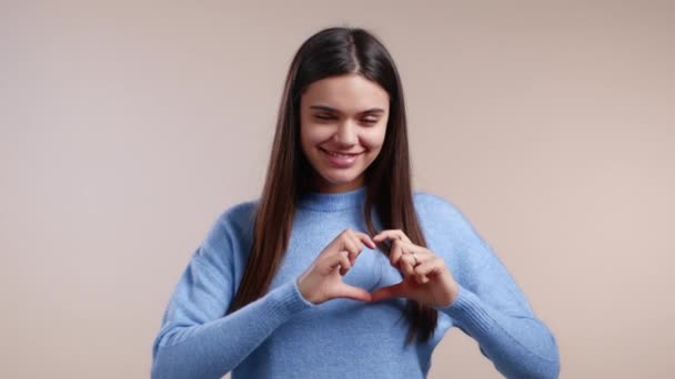 Gentile bella donna che fa segno di forma del cuore vicino al petto. Salute delle donne, volontariato, aiuto alla donazione e concetto di amore. — Video Stock