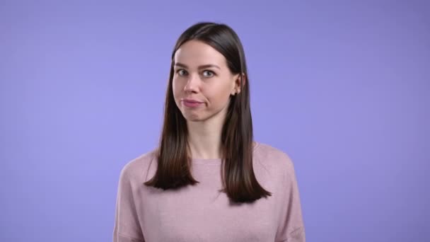 Inflexible woman disapproving with no head sign, nods head disapprovingly. Denying, Rejecting, Disagree, Portrait of pretty girl on violet studio background. — Stock Video