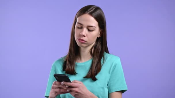 Woman using mobile phone on violet background. Technology, internet, social networks concept. — Stock Video