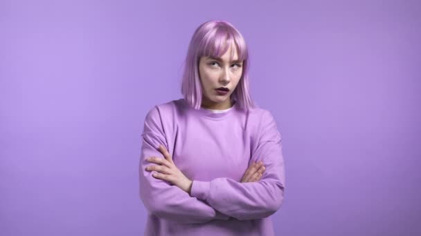 Young tired woman is dissatisfied, unhappy. She rolling eyes. Portrait of girl with trendy dyed colorful hairdo, she exhales from stuffiness. — Stock Video