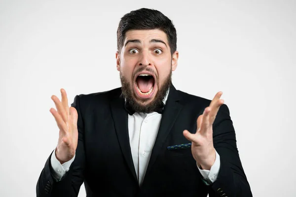 Man in tuxedo depicts amazement, showing WOW delight face effect. Surprised excited happy guy in shock. Handsome male model screaming on white background. — Stock Photo, Image