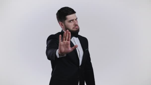 Portrait of serious man in tuxedo disapproving with no palm, hand sign make basta, negation, enough gesture. Denying, Rejecting, Disagree. Portrait of handsome guy on white background — Stock Video