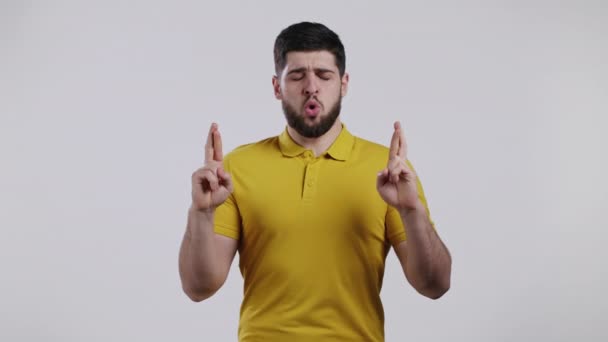 Young bearded man praying over white background. Guy begging someone satisfy his desires, help with. — Stock Video