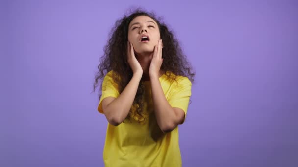 Young tired woman is dissatisfied, unhappy. She rolling eyes. Portrait of girl with curly hair, she exhales from stuffiness, bored because of work or study. — Stock Video