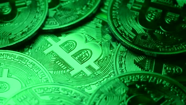 Bitcoin criptomoneda popular. Monedas girando en el sentido de las agujas del reloj bajo luz verde. Beneficio comercial del mercado, minería, inversión, concepto de ciberespacio. Fondo detallado de primer plano — Vídeos de Stock