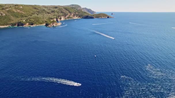 Aerial drone view to seascape with blue water. Driving jet ski. Motor boats sails and leaves mark on water surface. Amazing azure background. Travel destination, universal nature, powerboat sports — Stock Video