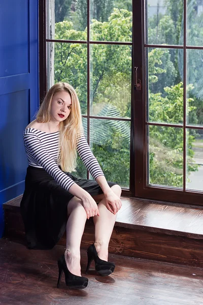 Beautiful girl near the windows at home — Stock Photo, Image