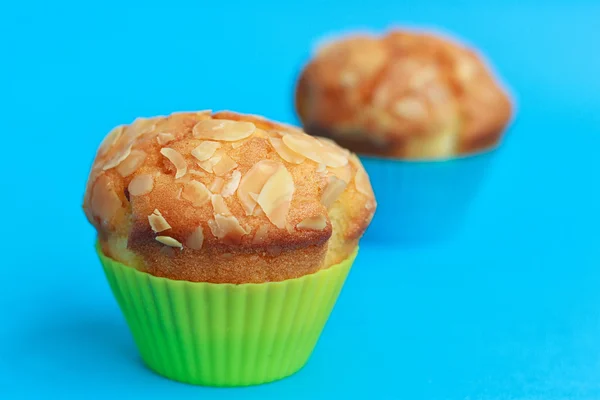 Muffins in silicone tins on a blue — Stock Photo, Image