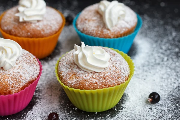 Muffins in colorful silicone forms — Stock Photo, Image