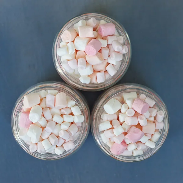 Three glass jars filled to brim marshmallow — Stock Photo, Image