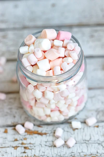 One glass jar filled up with marshmallow