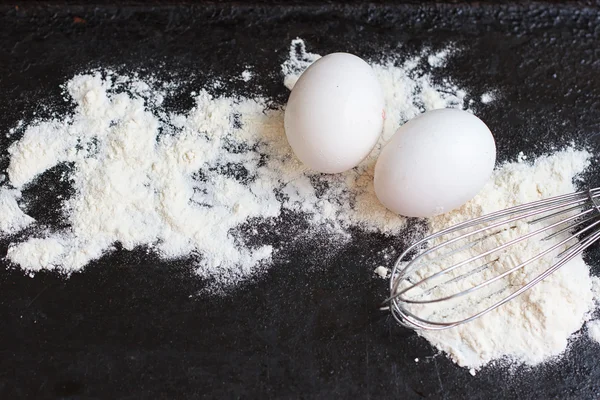 Ingredients for a cake on black stone — Stock Photo, Image